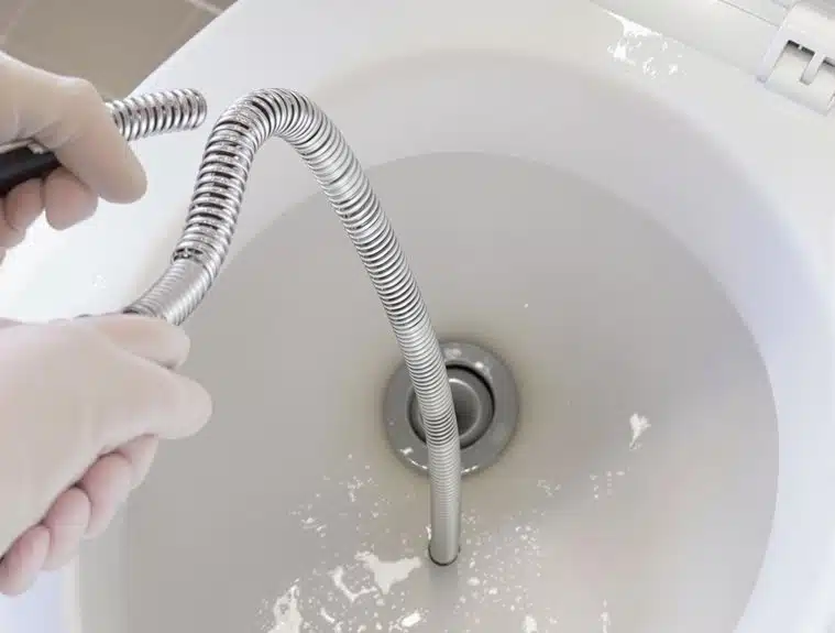 unclogging toilet with plumber s snake